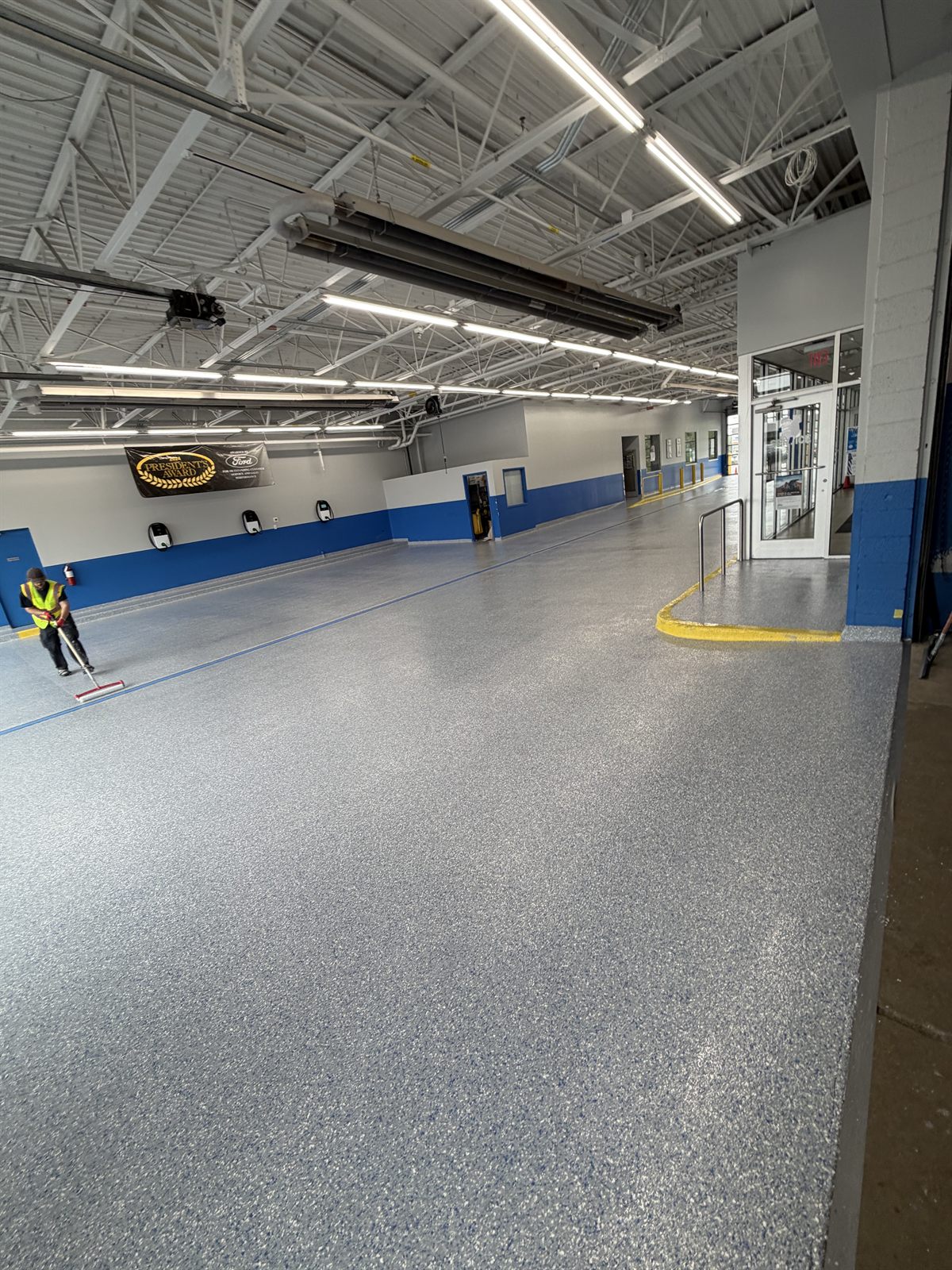 MavSeal UPA polyaspartic topcoat over a flake floor at an automotive dealership service drive