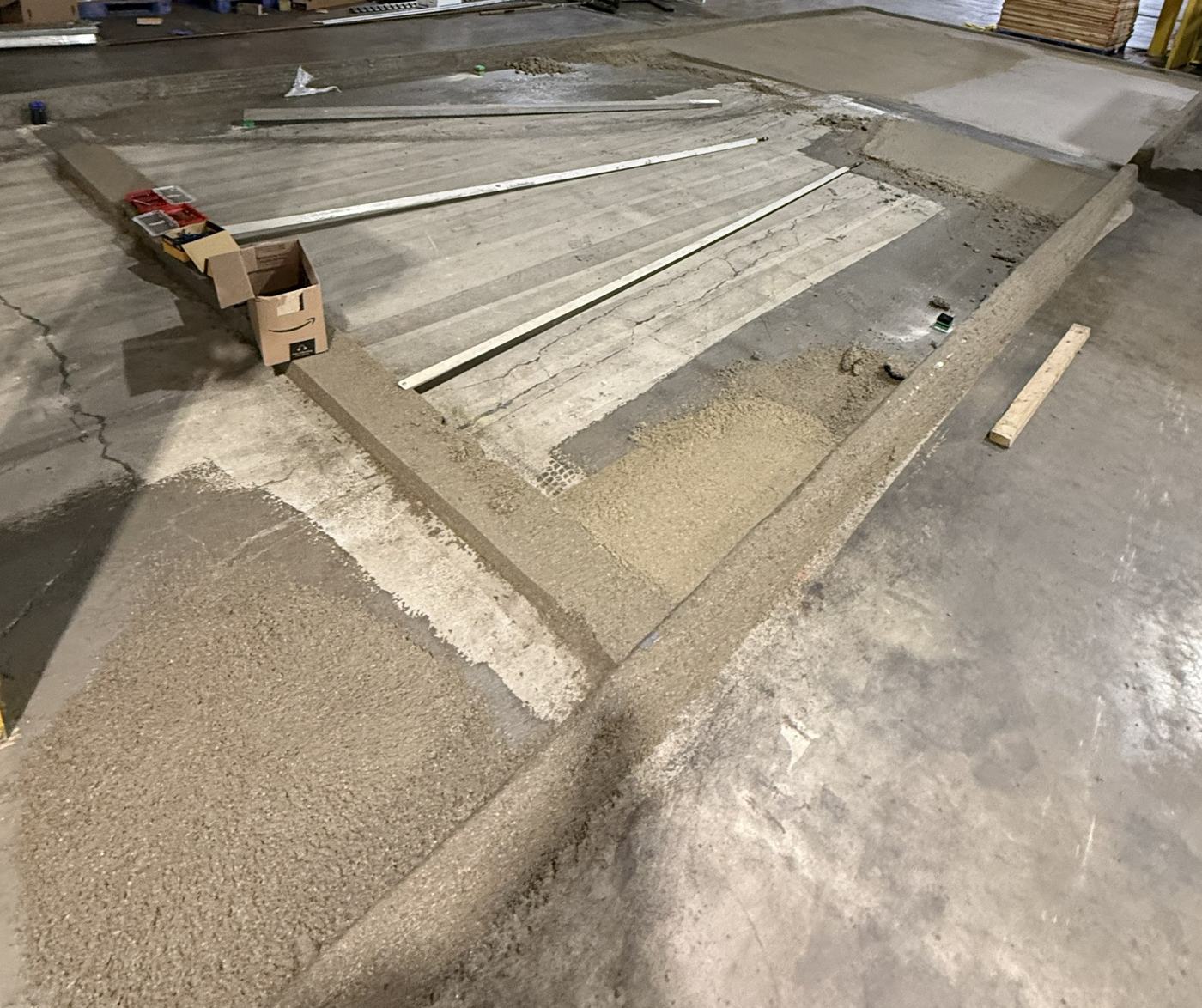 Sloped urethane cement overlay being screeded to grade
