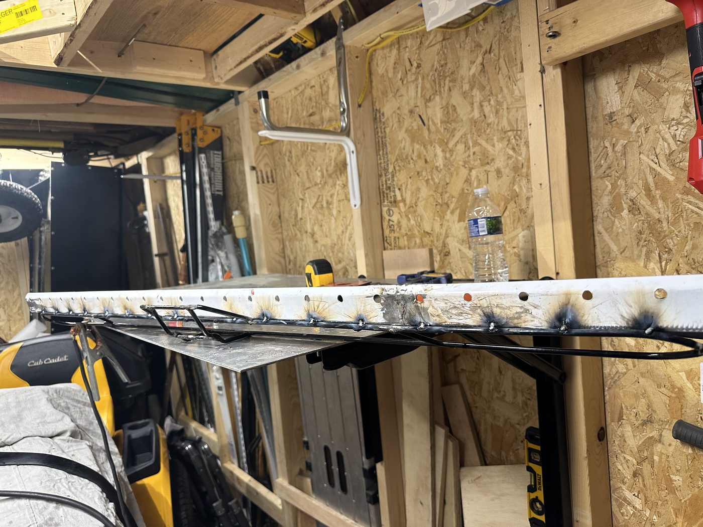 Completed 60-inch squeegee blade assembly on the fabrication bench