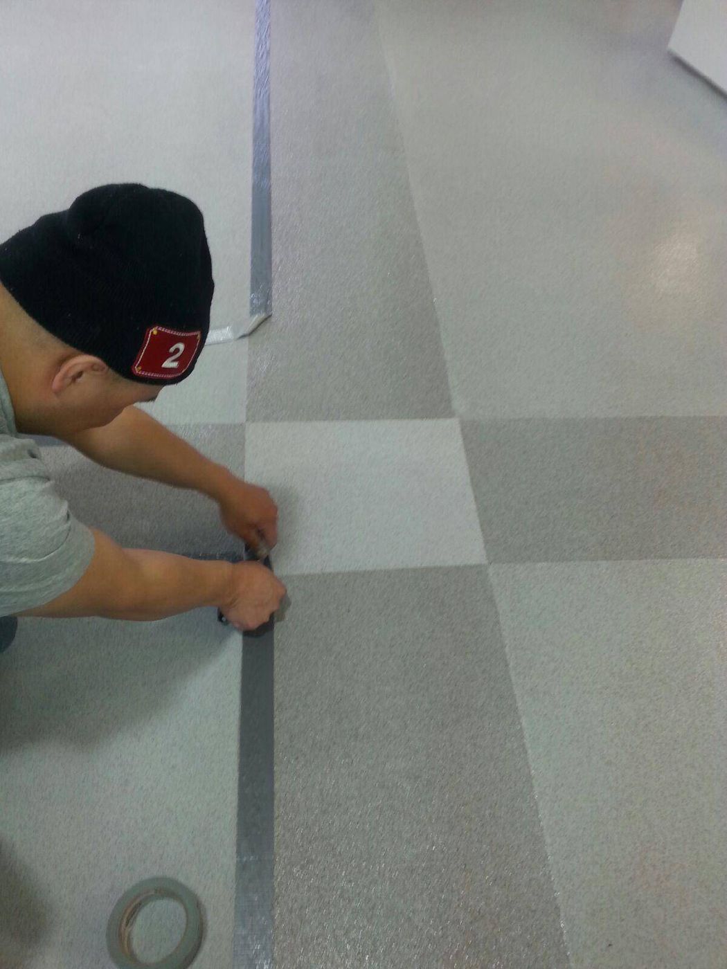 Two-tone quartz broadcast floor in checkerboard pattern, auto dealership — after installation