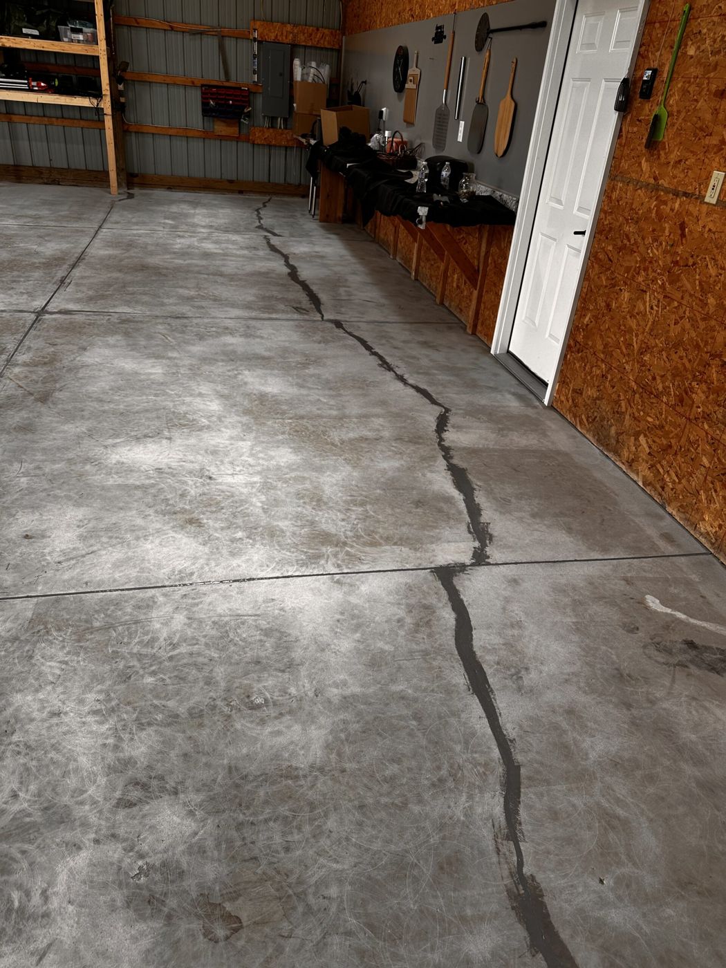 Concrete crack repair before MavTop UQB broadcast floor installation, storage shed