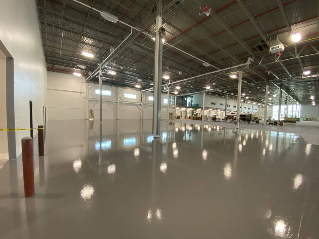 Glossy gray MavCoat epoxy floor across new warehouse space — after installation
