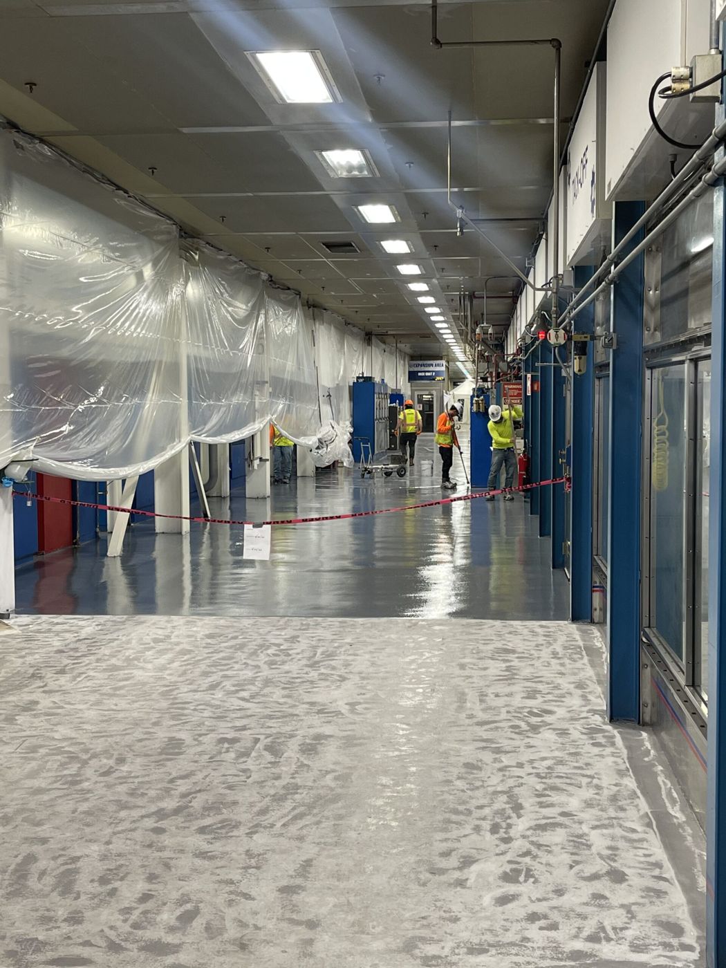 MavClad EM epoxy mortar with MavSeal UPA topcoat, assembly plant corridor, Detroit — during installation