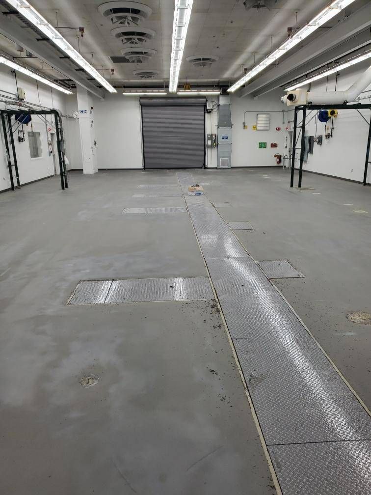 Battery storage facility floor during coating installation, automotive plant
