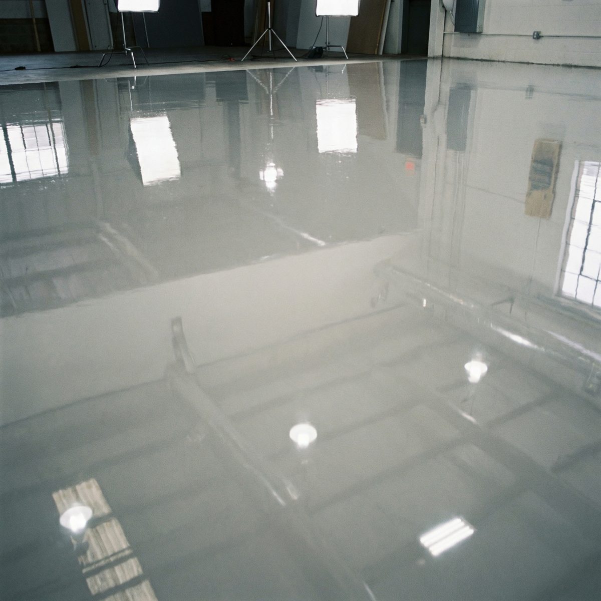 High-gloss self-leveling epoxy floor reflecting overhead facility lighting